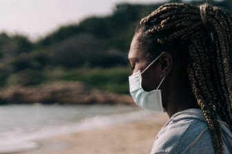 Woman in mask at beach