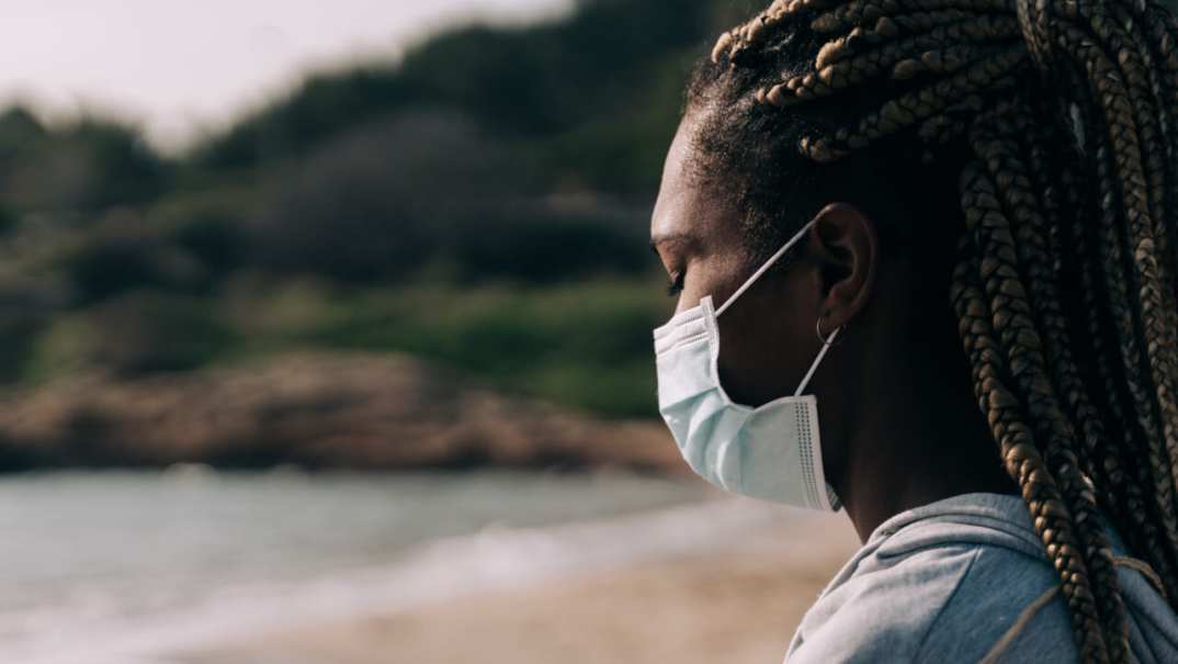 Woman in mask at beach