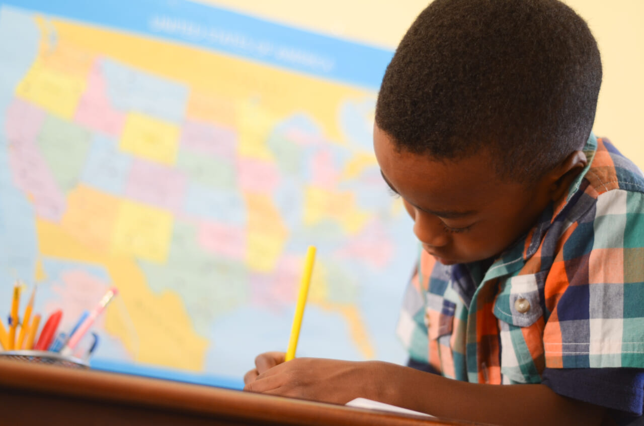 Black student doing school work in classroom, theGrio.com