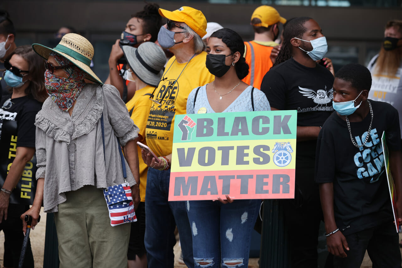 A group of protesters with a "Black Votes Matter" sign