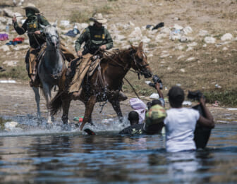 US Border Patrol on horse with Haitian migrants, theGrio.com