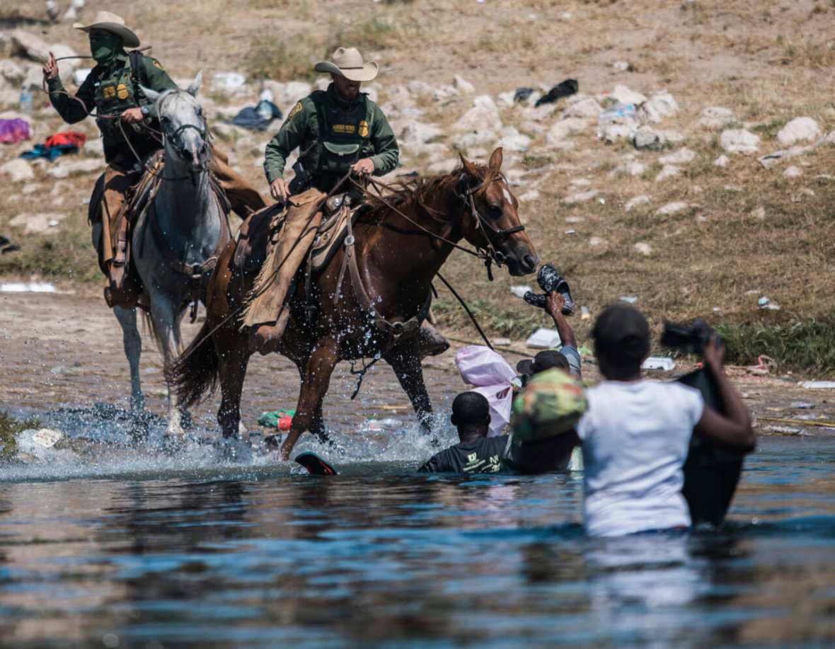 US Border Patrol on horse with Haitian migrants, theGrio.com