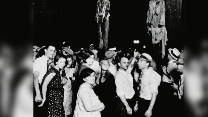 A crowd gathering to witness the killing of Thomas Shipp and Abram Smith, two victims of lynch law in Marion, Indiana