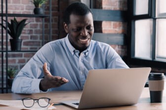Angry frustrated tired unhappy african american man in front of laptop