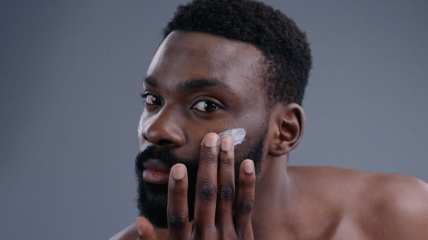 Black entrepreneur developing skin care line for dark skin men