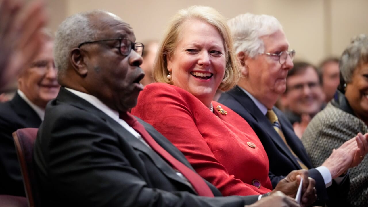 Associate Supreme Court Justice Clarence Thomas sits with his wife, conservative activist Virginia Thomas