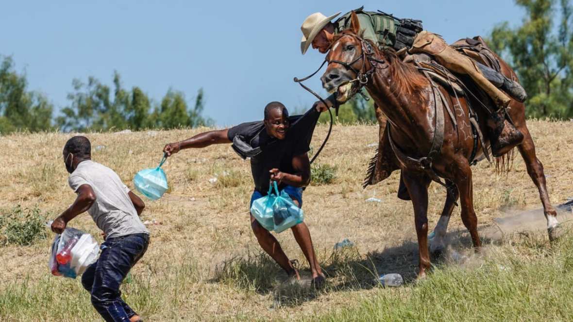 U.S. Border Patrol Agent on horseback tries to stop Haitian migrant from crossing the U.S.-Mexico border, theGrio.com