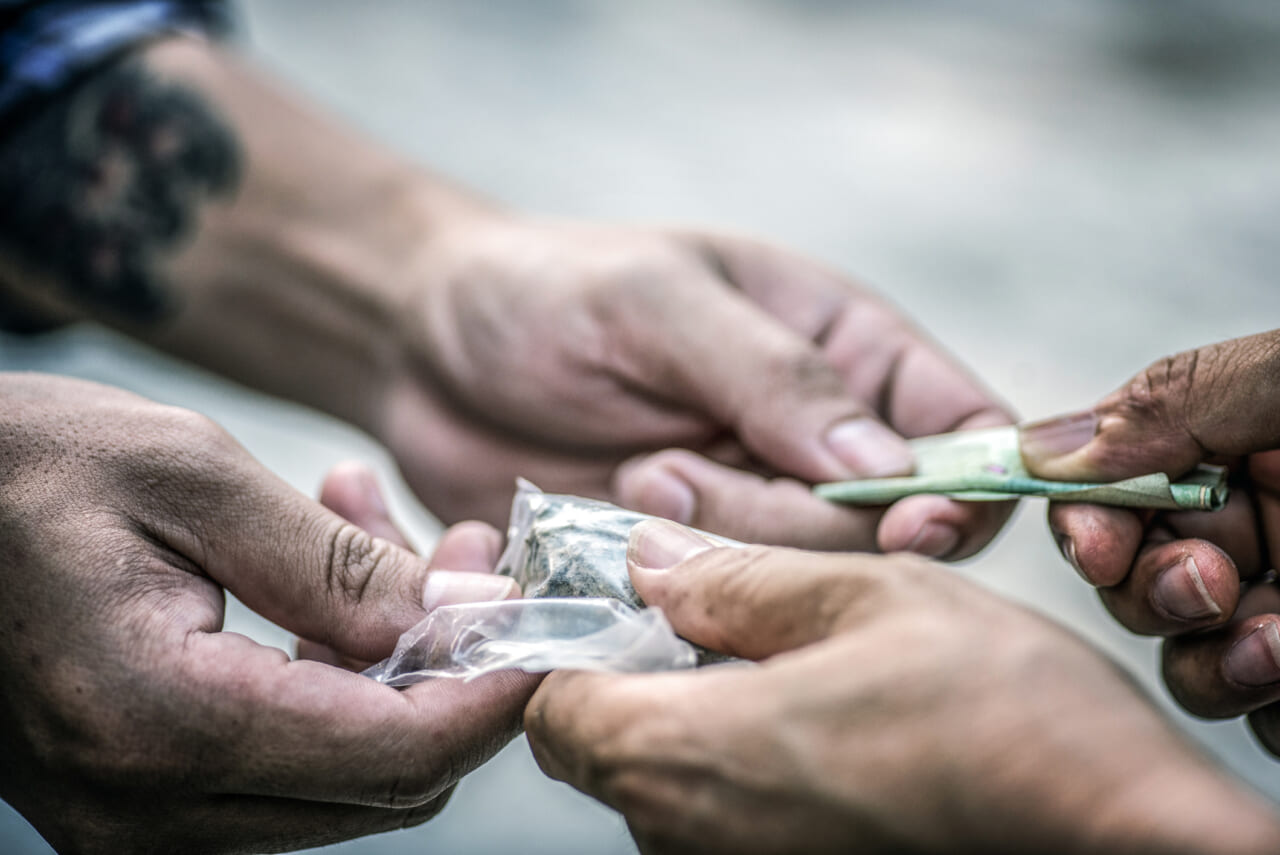 Hands of people completing a drug transaction