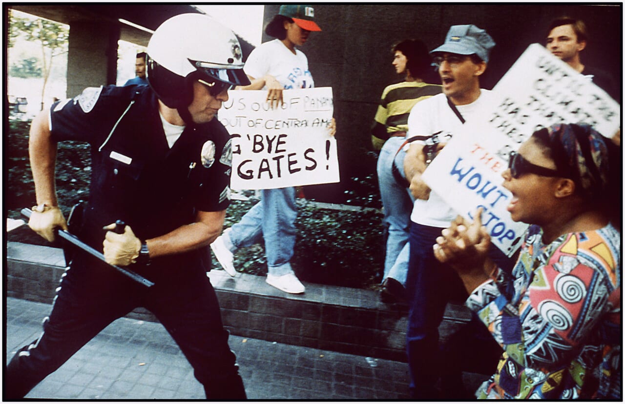 Police officer uses his baton on a protester