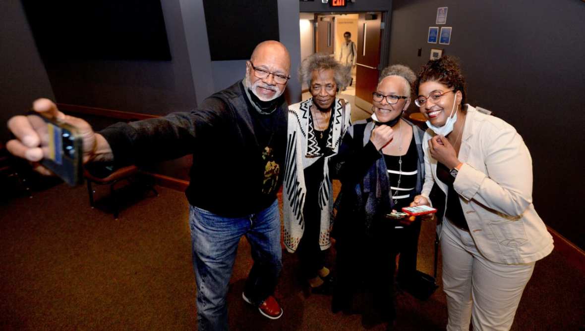 Tracey Meares, wearing an off-white pantsuit, at right, poses with friends