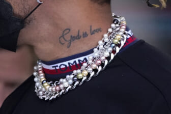 Racer Lewis Hamilton blinged for the gods to protest piercings crackdown