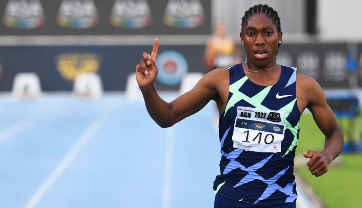 South African track star Caster Semenya points upward as she rounds the track