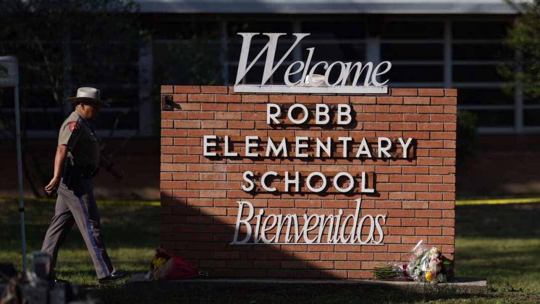 An officer walks outside of Robb Elementary School in Uvalde, Texas