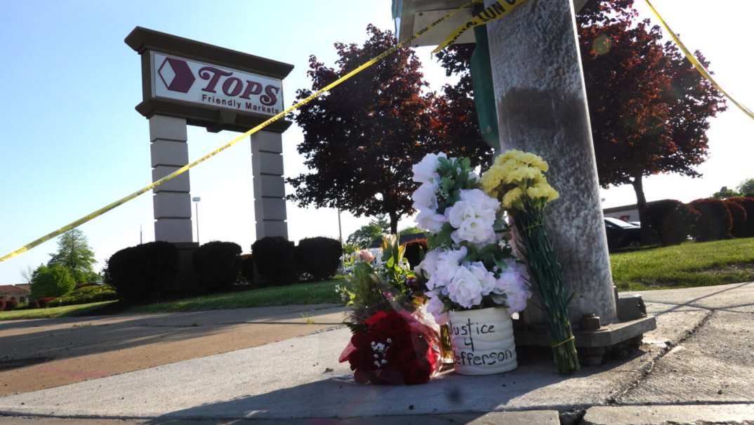 Flowers at a makeshift memorial outside Tops market