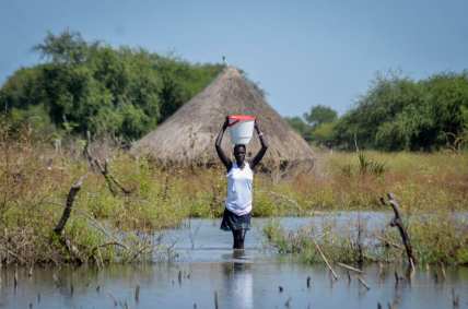 Woman carries water in Jonglei state of South Sudan, theGrio.com