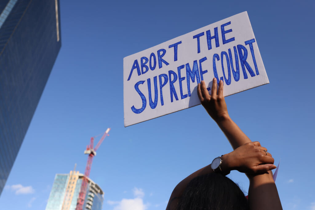 Abortion protestor holds up sign after Roe v. Wade overturned