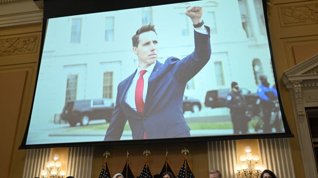 A screen displays an image of Republican Senator Josh Hawley of Missouri raising his fist to protesters on Jan. 6, 2021