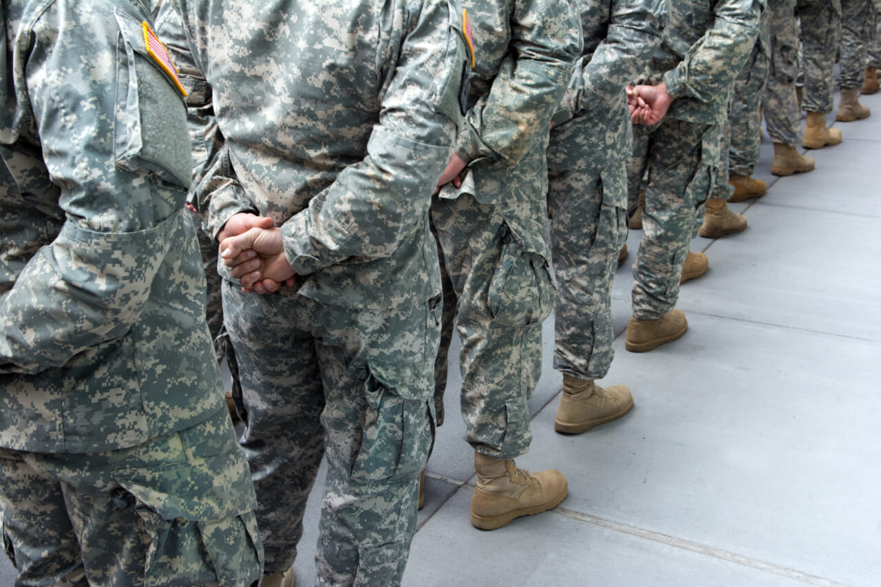 A line of soldiers wearing camouflage