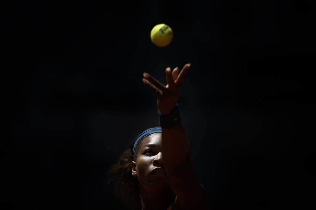 Tennis player Serena Williams throws a tennis ball up