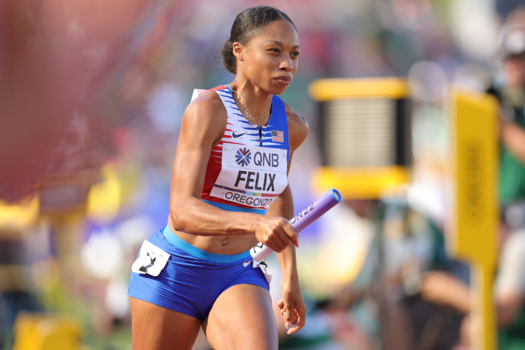 Track star Allyson Felix holding a baton