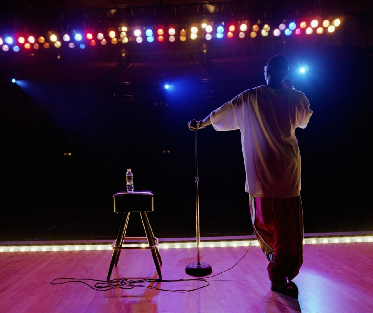 A man on stage facing the audience