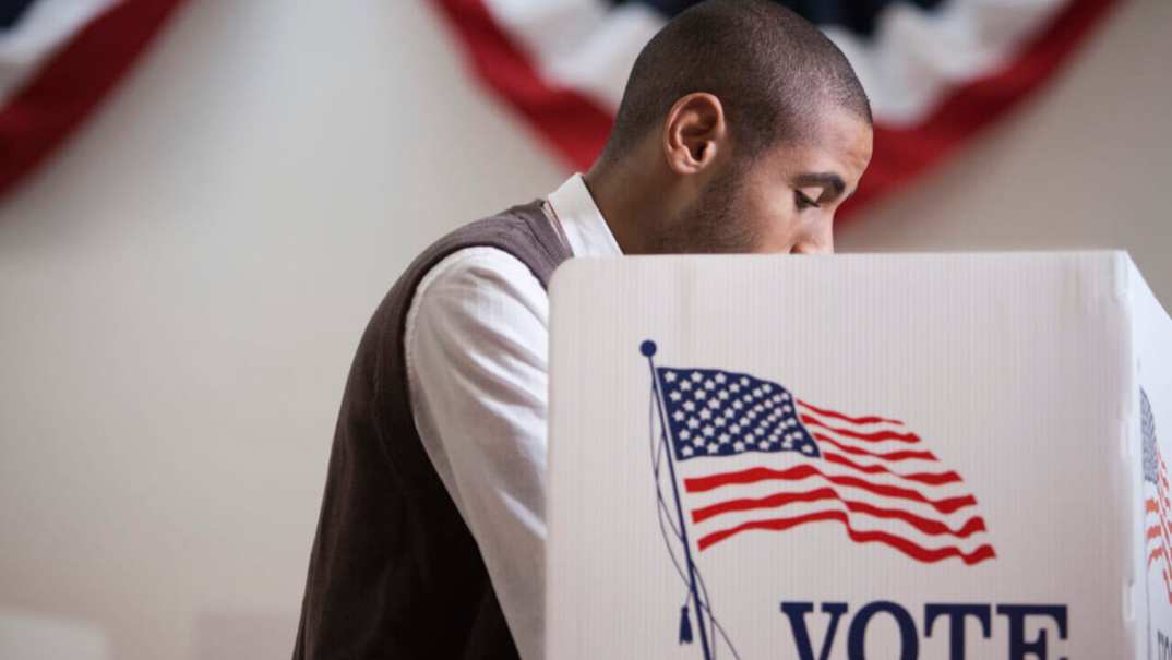 A man inside a voting booth