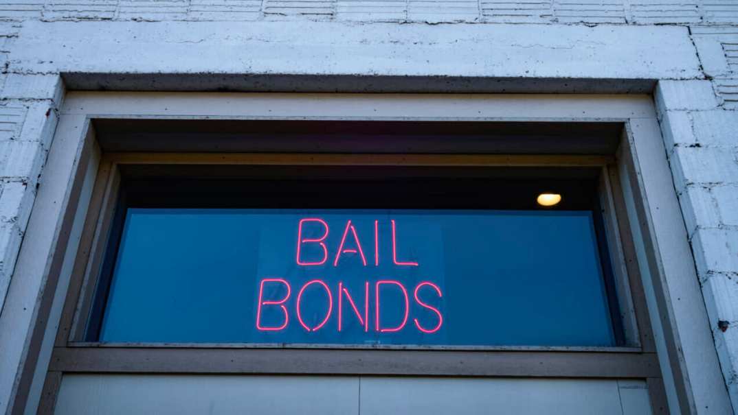 A neon sign reading "Bail Bonds"