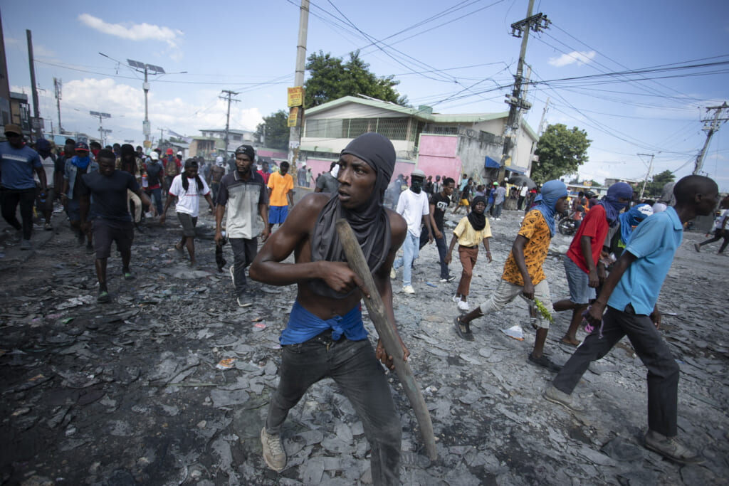 A protester carries a piece of wood simulating a weapon during a protest