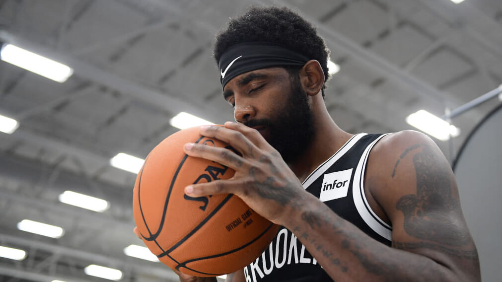 Kyrie Irving of the Brooklyn Nets holds a basketball