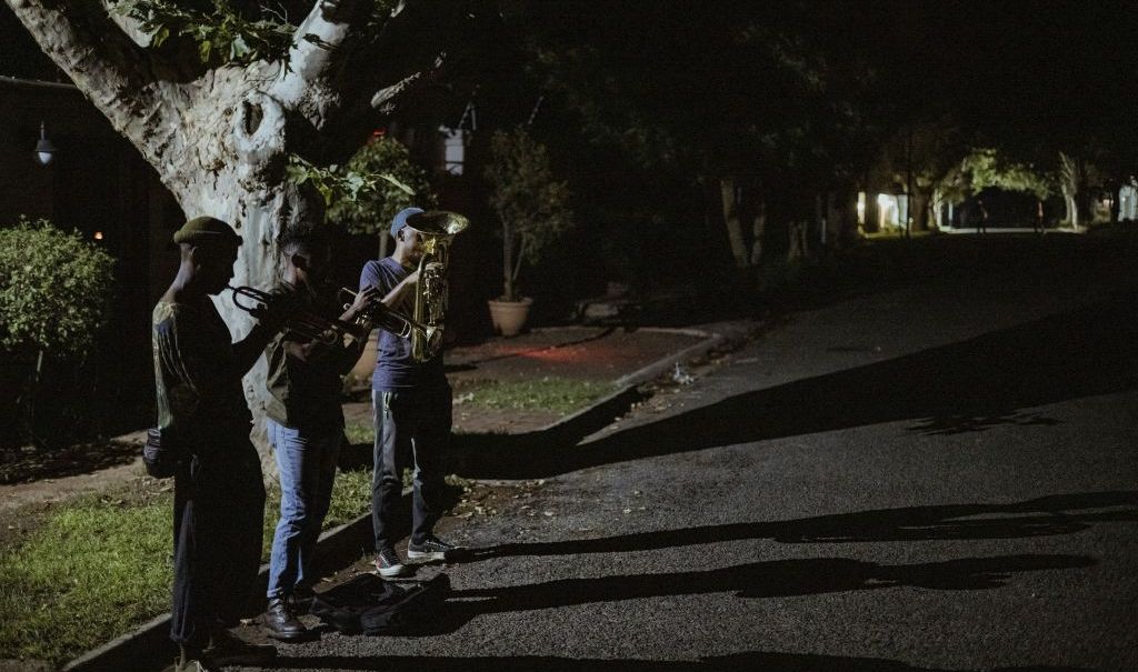 Members of The Middle of the Road Band Smiso, Franqo and Pro, play Christmas carols in Johannesburg