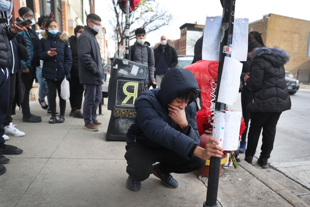 Friends and classmates visit a memorial for 15-year-old Caleb Westbrooks in the West Town neighborhood on January 19, 2022 in Chicago, Illinois. Half of America’s states sanction carrying a gun in public without first securing a license. All the data suggests that permitless carry could saddle the Black community with a heavy burden.