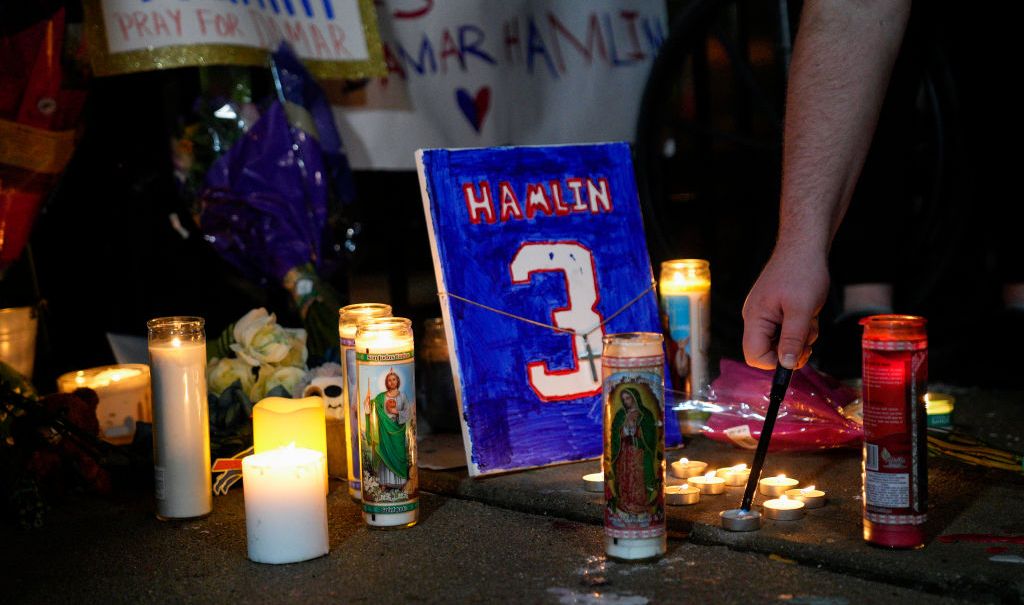 A memorial for Buffalo Bills safety Damar Hamlin showing candles and a plaque