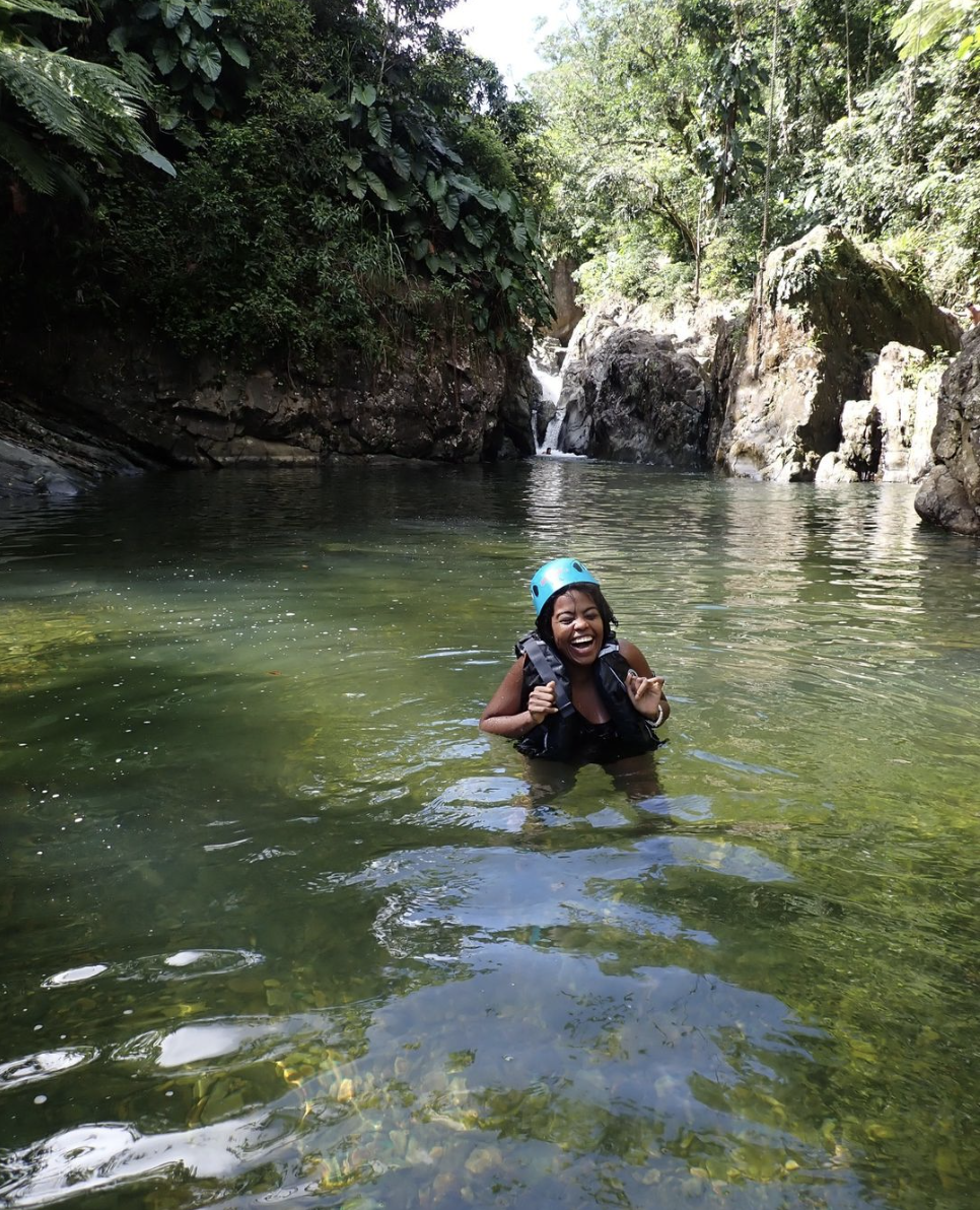 A traveler enjoys a dip in the water courtesy of Island Journeys PR tours.