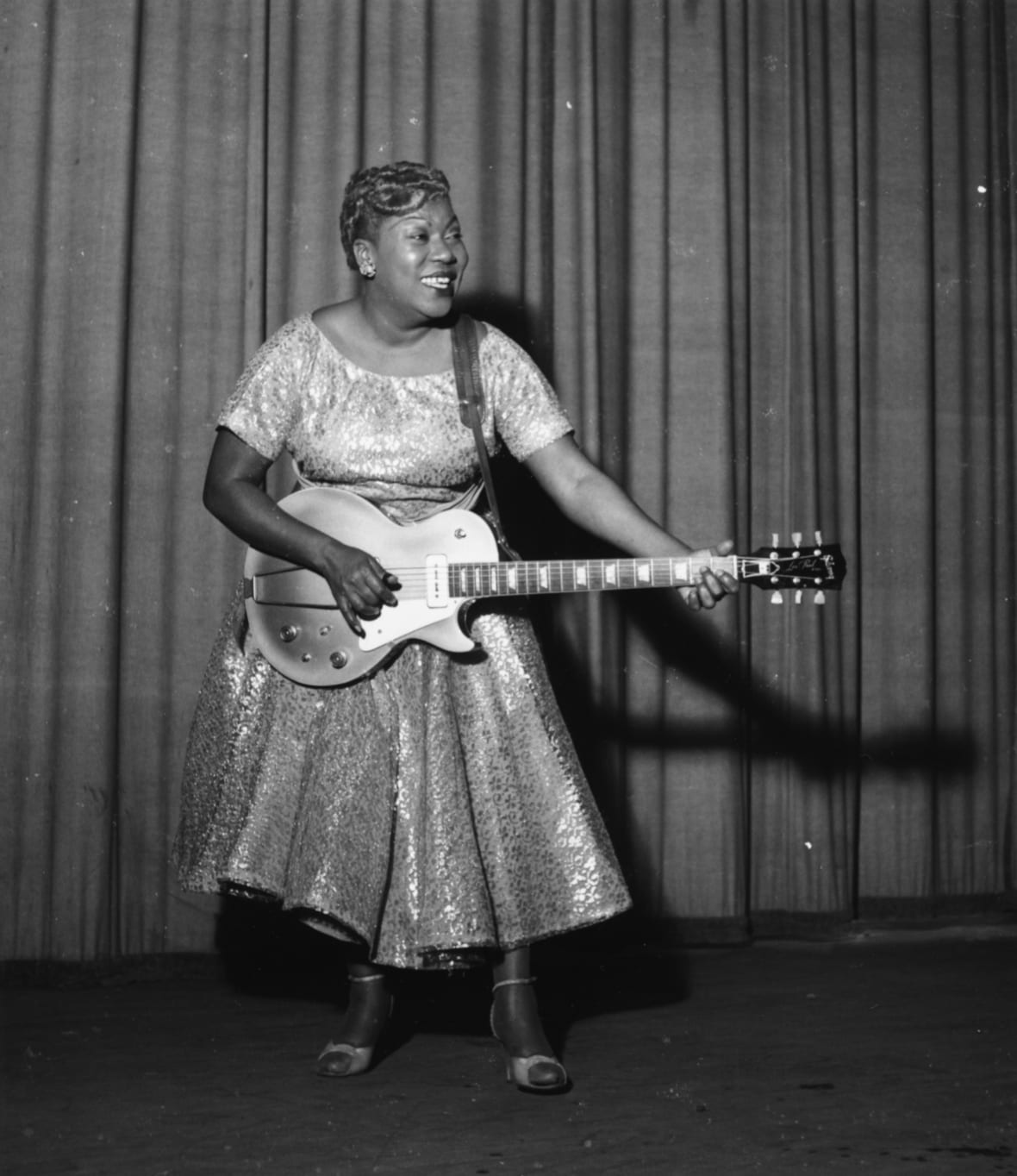 American singer Sister Rosetta Tharpe performing on stage with her guitar and Chris Barber's Jazz Band, Cardiff, Wales, November 1957. (Photo by Chris Ware/Keystone Features/Getty Images)