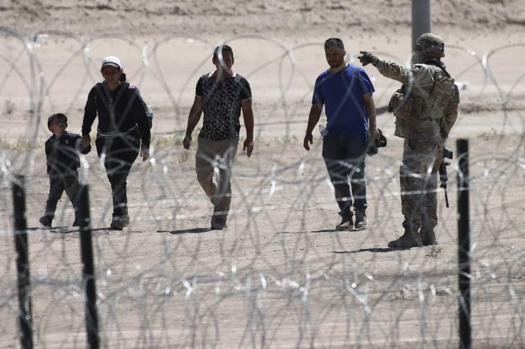 Migrants at the U.S.-Mexico border, theGrio.com