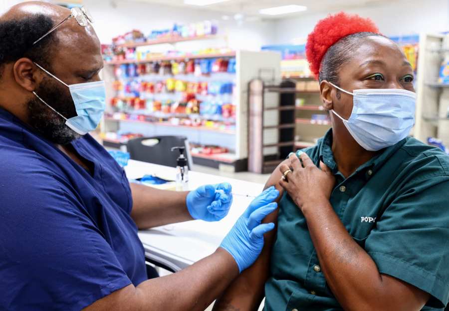 Licensed practical nurse Noah Johnson administers a COVID-19 vaccination dose as part of a vaccination campaign on Aug. 17, 2021, in Baton Rouge, Louisiana.