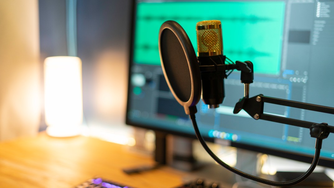 A microphone in front of a computer screen