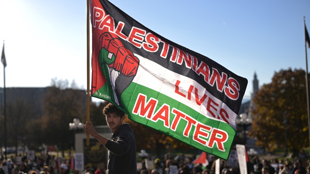 Al'Ammeer Mahmoud Hoj-Daen holds a "Palestinians Lives Matter" flag at a demonstration