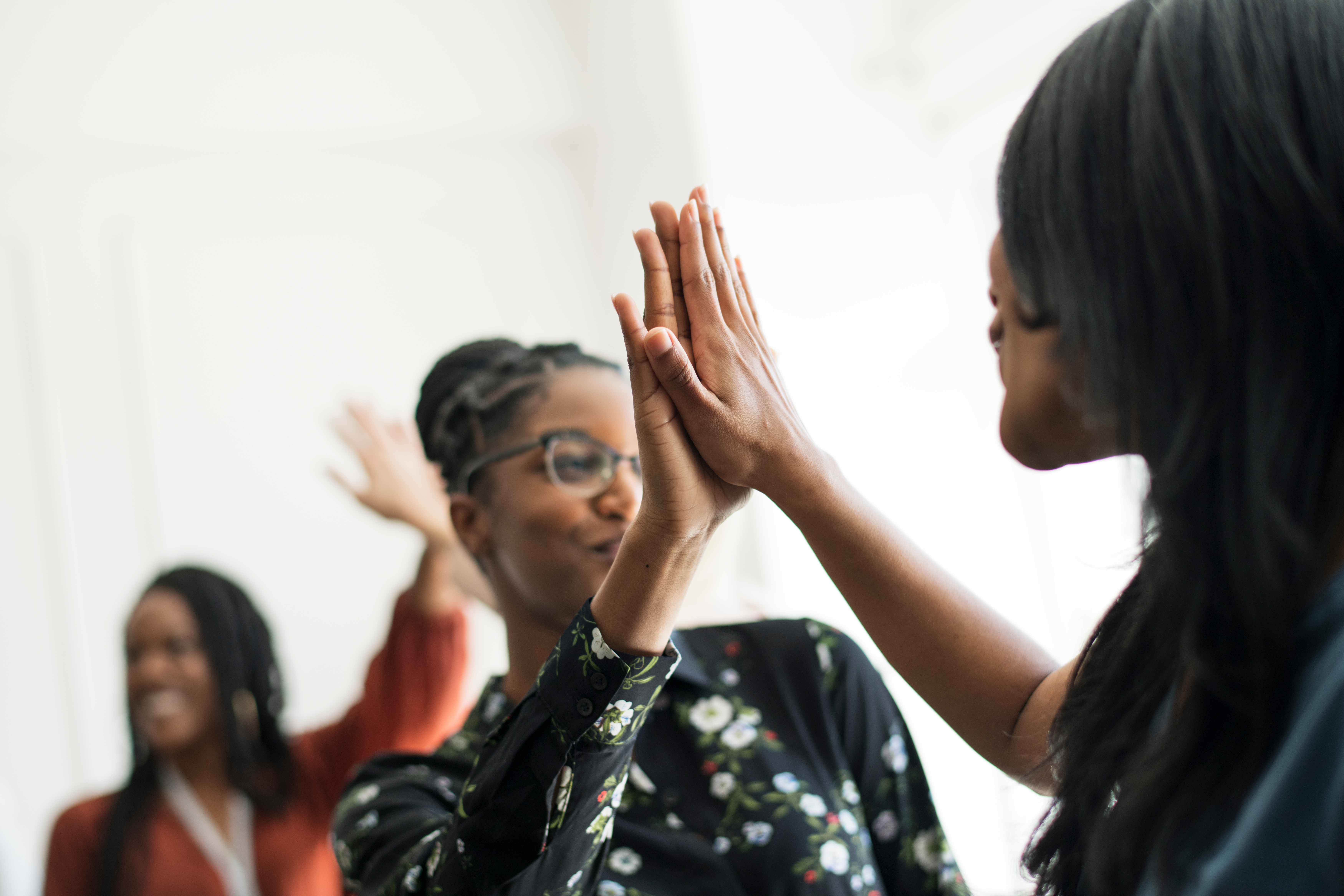 Young women high-fiving each other