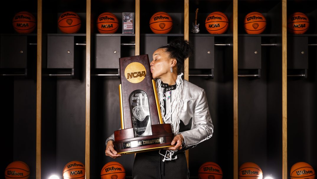 Head coach Dawn Staley of the South Carolina Gamecocks kisses the NCAA trophy