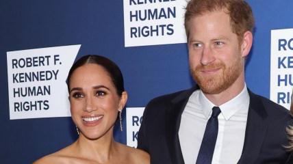Meghan Markle and Prince Harry, wearing a blue jacket and tie
