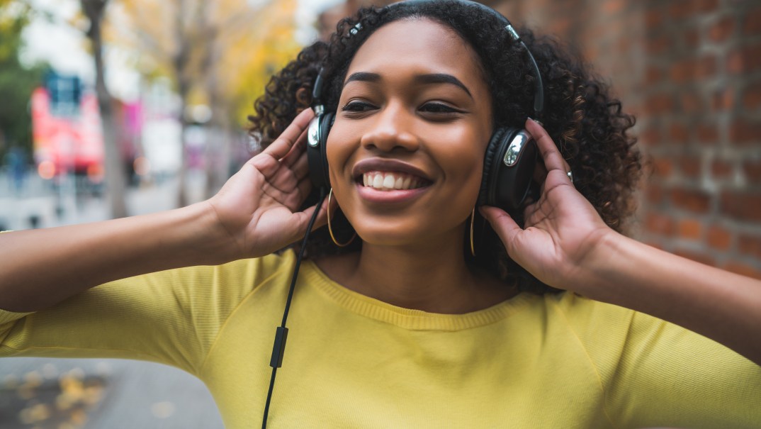 A young woman listens to headphones