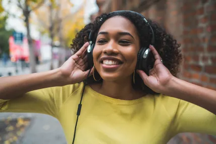 A young woman listens to headphones