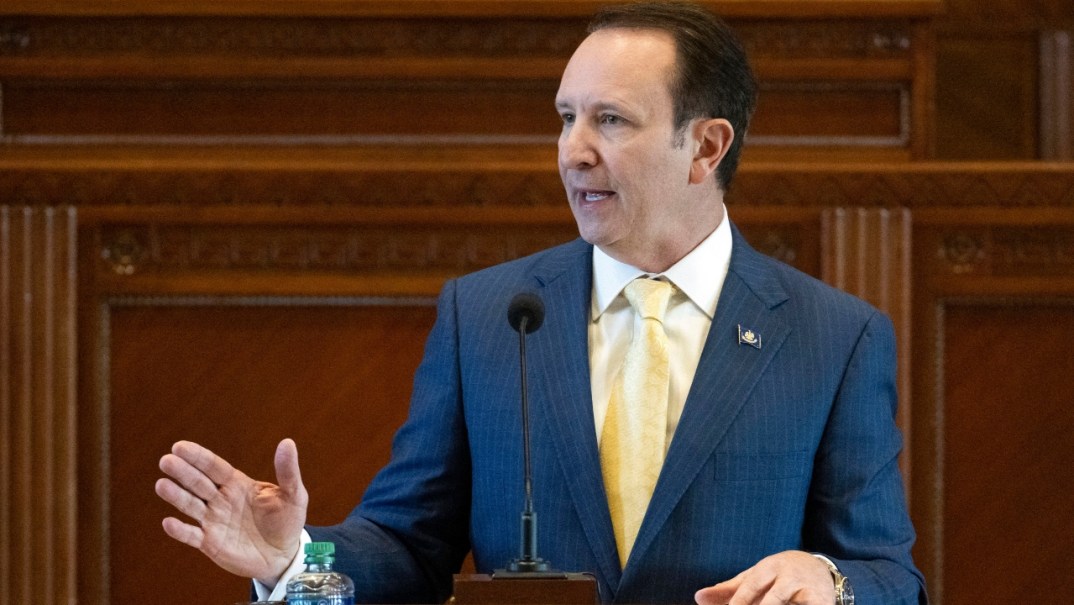 Louisiana Governor Jeff Landry wearing a blue pinstriped jacket and yellow tie