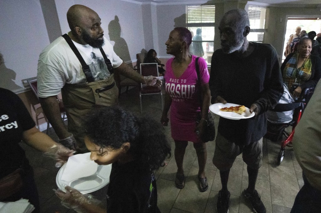 Rap artist Trae the Truth and his ReliefGang serve pizza